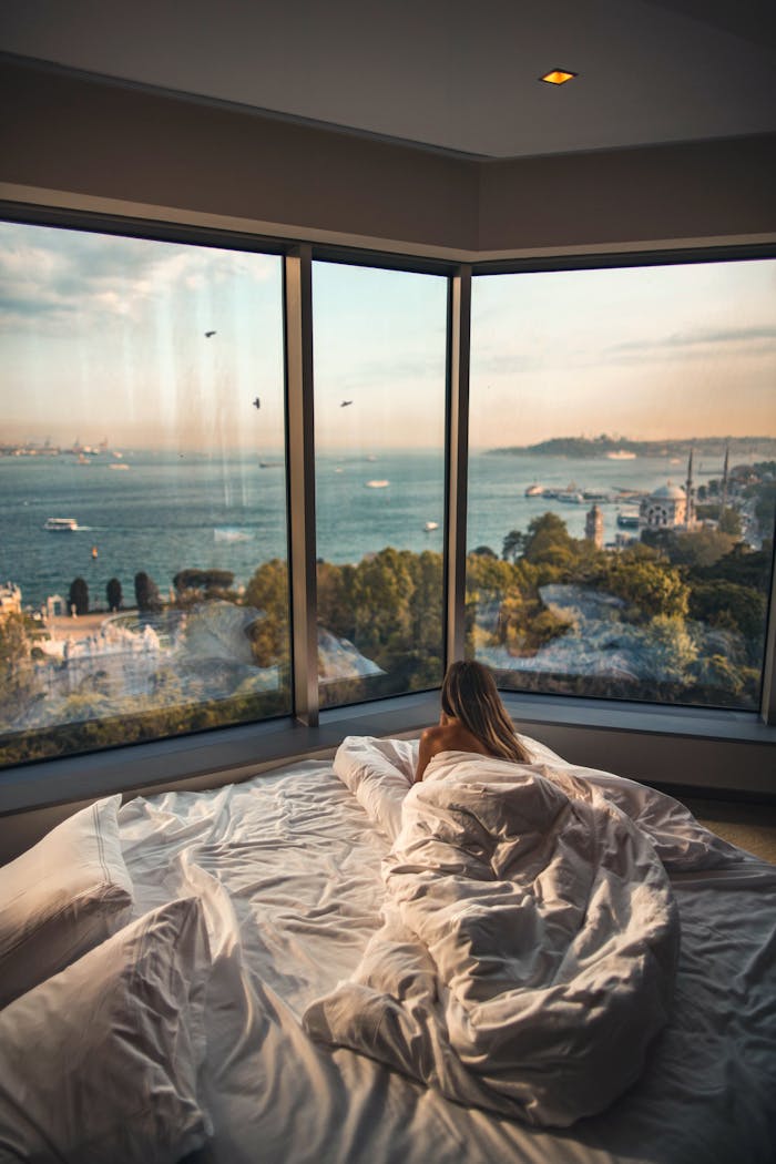 our-story Relaxing in a cozy hotel room with stunning views of the Bosphorus at sunset in Istanbul, Turkey.